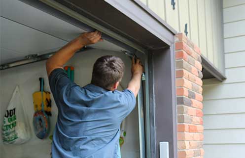 Technician Repairing Garage Door